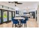 Eat-in kitchen featuring a modern table, blue velvet barstools, and modern stainless steel appliances at 1925 Grey Eagle St, Henderson, NV 89074
