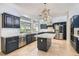 Elegant kitchen with blue cabinets, marble countertops, stainless steel appliances, and a central island at 1925 Grey Eagle St, Henderson, NV 89074