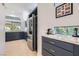 Modern kitchen features custom blue cabinets, stainless steel appliances, and marble countertops at 1925 Grey Eagle St, Henderson, NV 89074