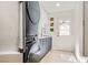 Efficient laundry room with modern appliances, white cabinets, and a sink, maximizing utility in a compact area at 1925 Grey Eagle St, Henderson, NV 89074