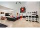 Open living space with bar and fireplace, featuring stylish seating and neutral tile flooring, perfect for entertaining at 1925 Grey Eagle St, Henderson, NV 89074