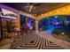 Outdoor patio with ceiling fan, mounted television, string lights, and outdoor furniture overlooking a landscaped backyard at 1925 Grey Eagle St, Henderson, NV 89074