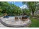 Beautiful backyard pool area featuring an in-ground pool, jacuzzi, patio, lush green landscaping and mature trees at 1925 Grey Eagle St, Henderson, NV 89074