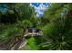 Secluded pool area with lounge chairs, mature trees, and manicured landscaping at 1925 Grey Eagle St, Henderson, NV 89074