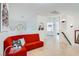 Bright sitting area with a red built-in sofa and neutral flooring, offering a comfortable and stylish transition space at 1925 Grey Eagle St, Henderson, NV 89074