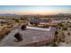 Aerial view of home's backyard featuring desert landscaping and brick privacy fence at 2051 Saginaw Ave, Pahrump, NV 89048