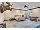 Large bedroom with neutral tones, fan and view of the backyard at 2051 Saginaw Ave, Pahrump, NV 89048