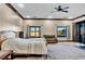 Large bedroom with neutral tones, fan and backyard view at 2051 Saginaw Ave, Pahrump, NV 89048