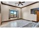 Cozy bedroom features a large window, tile flooring, and neutral wall color, creating a relaxing atmosphere at 2051 Saginaw Ave, Pahrump, NV 89048