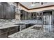 Modern kitchen featuring gray cabinets, granite countertops, stainless steel appliances, and stone backsplash at 2051 Saginaw Ave, Pahrump, NV 89048