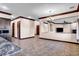 Open-concept living room with tile flooring, decorative lighting, and entryways to dining and Gathering room at 2051 Saginaw Ave, Pahrump, NV 89048