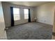 This bedroom features large windows with a view, carpet floors, and neutral decor at 2064 Mesquite Ln # 304, Laughlin, NV 89029
