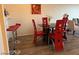 This dining area features a modern table set, red chairs, and hardwood floors at 2064 Mesquite Ln # 304, Laughlin, NV 89029