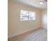 Bright bedroom features a window with bars and a hardwood-style floor at 208 N Bruce St # A, Las Vegas, NV 89101