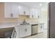 Clean kitchen design featuring white cabinets, black hardware, modern fixtures, and stainless steel appliances at 208 N Bruce St # A, Las Vegas, NV 89101