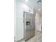 A kitchen featuring stainless steel refrigerator with white cabinetry and hardware at 208 N Bruce St # A, Las Vegas, NV 89101