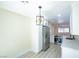 Open kitchen layout with stainless steel appliances, modern lighting, and marble countertops at 208 N Bruce St # A, Las Vegas, NV 89101