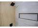 Modern shower featuring sleek tile, a niche, and a stylish, black square shower head and handle at 208 N Bruce St # A, Las Vegas, NV 89101
