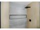 Modern tiled shower with a niche, rain shower head, and matte black fixtures at 208 N Bruce St # A, Las Vegas, NV 89101