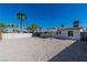 Expansive backyard with gravel, perimeter fencing, and a covered patio, perfect for outdoor activities at 2105 Berkley Ave, Las Vegas, NV 89101