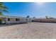 Large gravel backyard featuring a covered patio and block wall, offering privacy and space for outdoor entertaining at 2105 Berkley Ave, Las Vegas, NV 89101