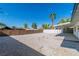Spacious gravel backyard with a covered patio, offering ample room for outdoor activities and landscaping at 2105 Berkley Ave, Las Vegas, NV 89101