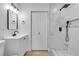 Updated bathroom featuring a modern walk-in shower with white marble-style tile and matte black fixtures at 2105 Berkley Ave, Las Vegas, NV 89101