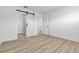 Modern bedroom with a sliding barn door leading to the bathroom and wood-look tile flooring at 2105 Berkley Ave, Las Vegas, NV 89101