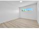 Inviting bedroom with wood-look floors and a bright window offering natural light at 2105 Berkley Ave, Las Vegas, NV 89101