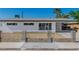 Curb appeal of this modern home is enhanced by the decorative white fence at 2105 Berkley Ave, Las Vegas, NV 89101