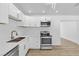 Bright kitchen features white cabinetry, stainless appliances, and quartz countertops at 2105 Berkley Ave, Las Vegas, NV 89101