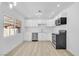 A bright, modern kitchen featuring stainless steel appliances, white cabinets, and contemporary lighting at 2105 Berkley Ave, Las Vegas, NV 89101