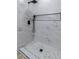 Modern shower featuring beautiful marble tiling, black fixtures, and a convenient built-in shelf at 2105 Berkley Ave, Las Vegas, NV 89101