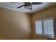 Bedroom with neutral walls features a ceiling fan and a window with closed shutters at 2153 Jade Creek St # 106, Las Vegas, NV 89117