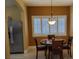 Cozy dining area with a round table, pendant lighting, and plantation shutters for a bright and inviting space at 2153 Jade Creek St # 106, Las Vegas, NV 89117