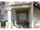 Inviting condo entrance featuring a covered porch with seating area, offering a welcoming first impression at 2153 Jade Creek St # 106, Las Vegas, NV 89117