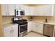 Well-equipped kitchen with white cabinetry, stainless steel appliances, and modern finishes at 2153 Jade Creek St # 106, Las Vegas, NV 89117
