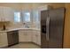 Bright kitchen featuring white cabinets, stainless steel appliances, and a corner sink with natural light at 2153 Jade Creek St # 106, Las Vegas, NV 89117