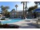 Community pool with seating and lush mature landscaping is ready for relaxing in the sun at 2153 Jade Creek St # 106, Las Vegas, NV 89117