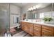 Bathroom featuring a double sink vanity, walk-in shower, and modern fixtures at 230 S Weeping Willow Ct, Pahrump, NV 89048