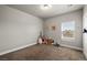 Cozy bedroom featuring neutral walls, soft carpet, and a bright window at 230 S Weeping Willow Ct, Pahrump, NV 89048