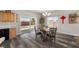 Bright dining area featuring modern lighting, laminate floors, and a sliding glass door to the patio at 230 S Weeping Willow Ct, Pahrump, NV 89048