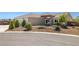 Charming single-story home featuring desert landscaping, a tile roof, and an attached two-car garage at 230 S Weeping Willow Ct, Pahrump, NV 89048