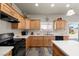 Bright kitchen with stainless steel appliances, wood cabinets, and white countertops at 230 S Weeping Willow Ct, Pahrump, NV 89048