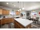 Open kitchen and dining area with center island, light fixtures and sliding glass doors at 230 S Weeping Willow Ct, Pahrump, NV 89048