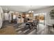 Open-concept kitchen and dining area featuring wood cabinets, stainless steel appliances, and a sliding door to the backyard at 230 S Weeping Willow Ct, Pahrump, NV 89048