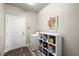 Bright laundry room with washer, dryer, shelving for storage, and convenient access to the door at 230 S Weeping Willow Ct, Pahrump, NV 89048