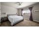 Inviting bedroom with comfortable bed, ceiling fan, and bright window at 230 S Weeping Willow Ct, Pahrump, NV 89048