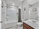 Clean bathroom with a shower-tub combo, updated fixtures, and a vanity with storage space at 2383 Elmont Ave, North Las Vegas, NV 89086