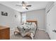 Cozy bedroom with carpet, ceiling fan, and a comfortable bed with neutral decor and bright light at 2383 Elmont Ave, North Las Vegas, NV 89086